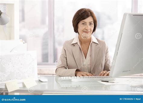 Portrait Of Senior Businesswoman At Office Desk Stock Photo Image Of