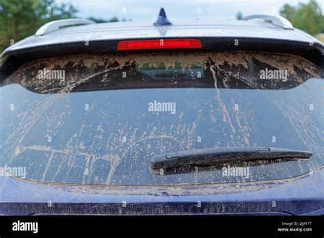 Dirty Car Glass With Wiper And Third Brake Light Rear Window Covered