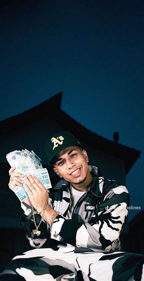 A Man Sitting At A Table With Money In His Hand