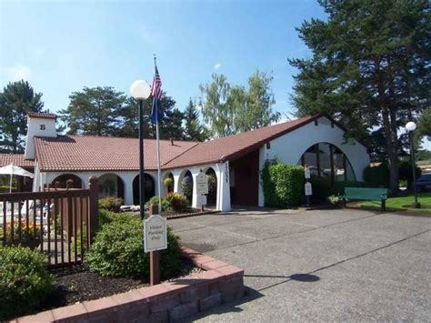 A Building With An American Flag On The Roof And Flags Flying In The