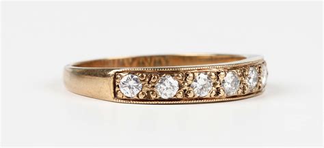 A Gold And Diamond Seven Stone Half Eternity Ring Mounted With