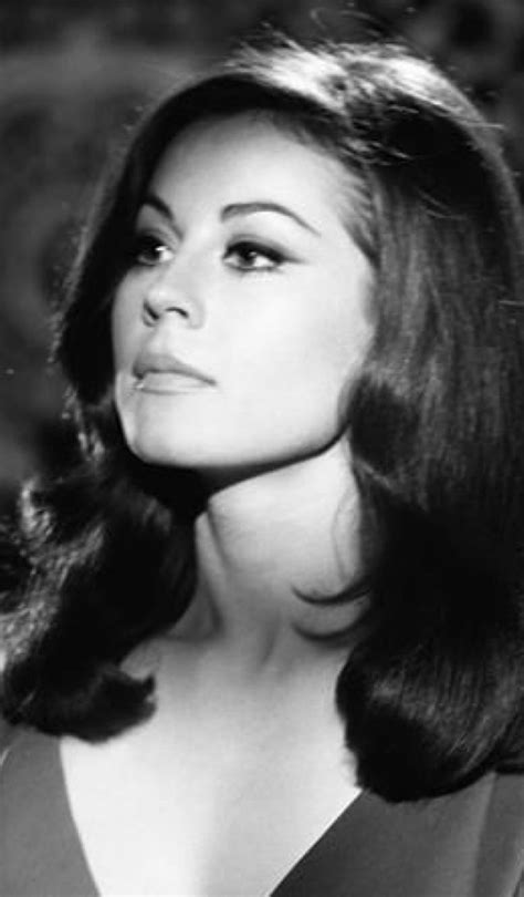 An Old Black And White Photo Of A Woman With Her Hair In The Air