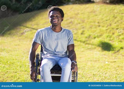 Handsome Black Guy In Wheelchair Having Fun On Sunny Day Stock Photo