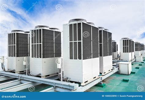 A Row Of Air Conditioning Units On Rooftop With Blue Sky Stock Photo