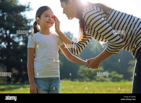 Gentle Mother Stroking Her Daughters Cheek Stock Photo Alamy