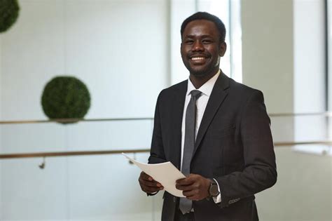 Premium Photo Smiling Businessman Holding Documents