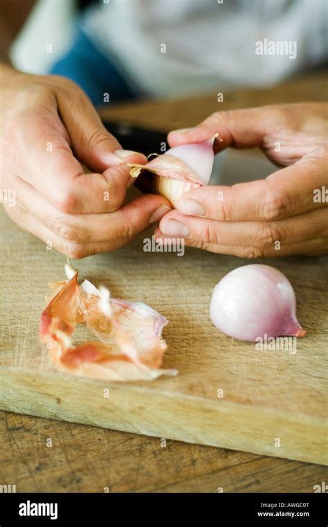 Hands Peeling An Onion Stock Photo Alamy