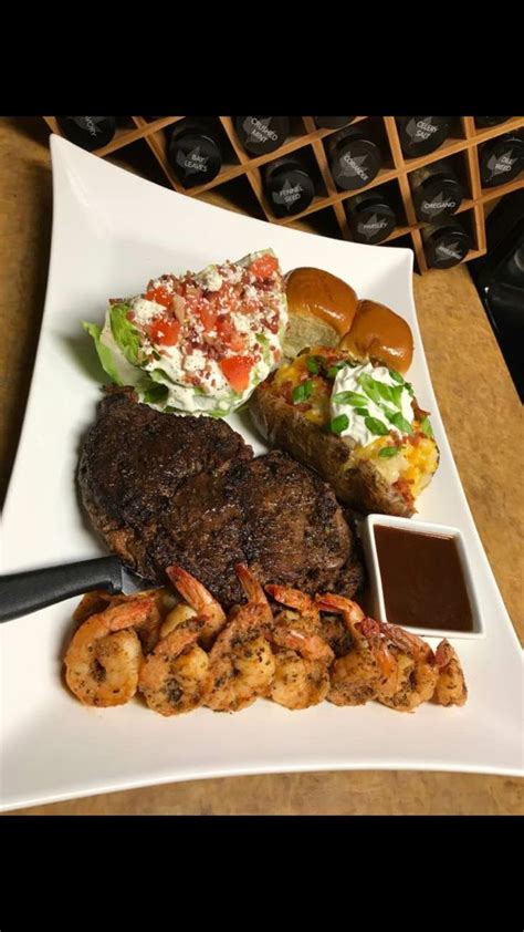 Surf And Turf With Loaded Baked Potato Classic Wedge Of Lettuce And Homemade Dinner Rolls Bon