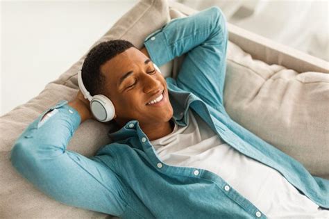 Premium Photo Satisfied Millennial African American Male Lies On Sofa