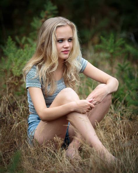 Pretty Blond Teenager Sitting In The Grass Stock Image Image Of Motive