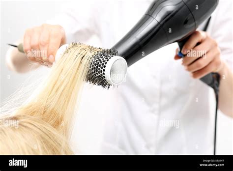 drying hair on a round brush Stock Photo - Alamy