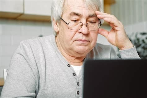 Premium Photo Old Man Thinking At Laptop Pensive Mature Grey Hair 60s