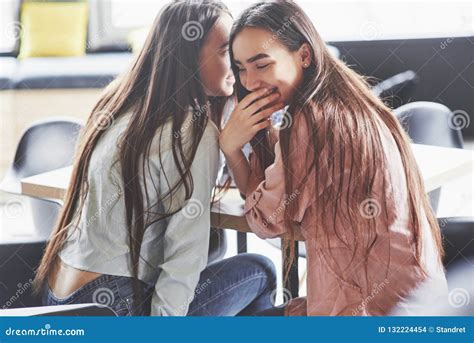 Two Beautiful Twin Girls Spend Time Sisters Relaxing In A Cafe And