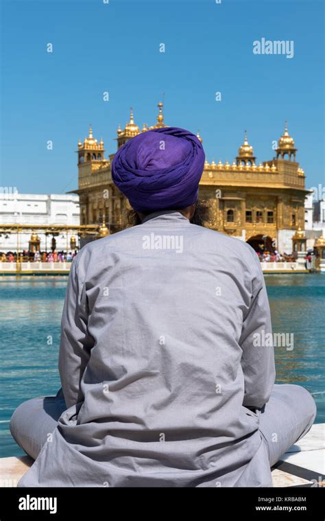 Vertical Picture Of Sikh Man Praying In Front Of The Lake At Sri