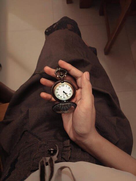 Premium Photo Cropped Hand Of Person Holding Pocket Watch