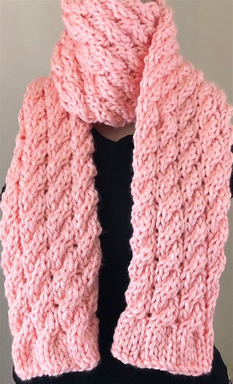 A Pink Knitted Scarf On Top Of A Mannequin