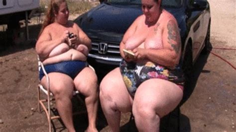 BBW Lola LoveBug And SSBBW Monika Mynx Is Smoking Outdoors Topless By The Car And Blowing Smoke