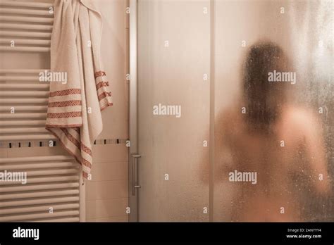 Sexy Naked Brunette Woman Take A Shower Inside The Shower Cabin Seen Through Foggy Glass In Her