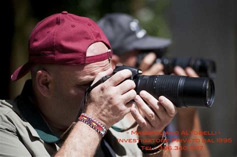 A Man Taking Pictures With His Camera And Other People In The Back