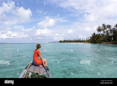 Attractive Woman In Orange Dress Sitting On Top Of The Boat Cruising In