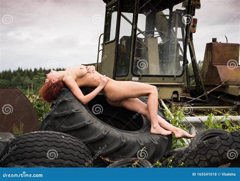 Nude Redhead Woman Posing On A Large Tractor Wheels Stock Photo Image