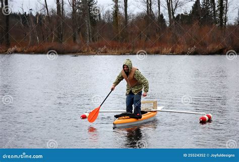 Man Standing In Canoe Stock Photography - Image: 25524352