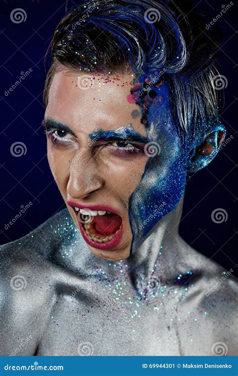 A Young Guy Androgyne Model In A White Sweater With A Rainbow Symbol