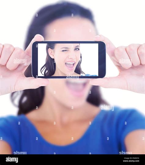 Composite Image Of Pretty Brunette Winking At Camera Stock Photo Alamy