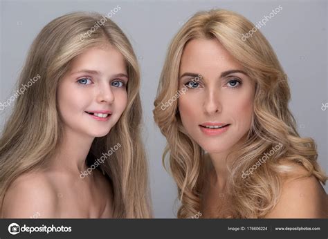 Happy Woman And Pretty Girl Are Expressing Contentment Stock Photo