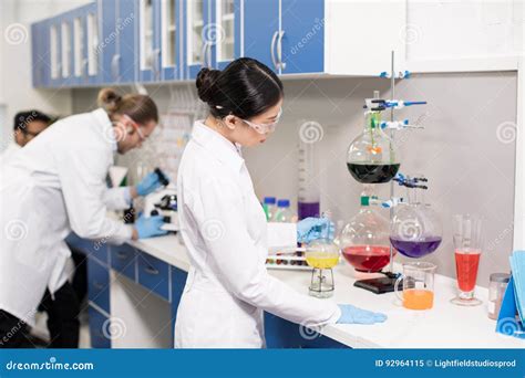 Young Professional Scientists Making Experiment In Research Laboratory