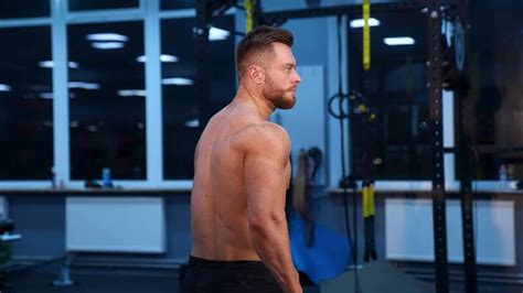 Strong Athletic Man In Sports Center Muscular Bodybuilder Showing His Naked Torso In Gym