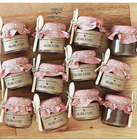 Small Jars Filled With Jam Sitting On Top Of A Wooden Table