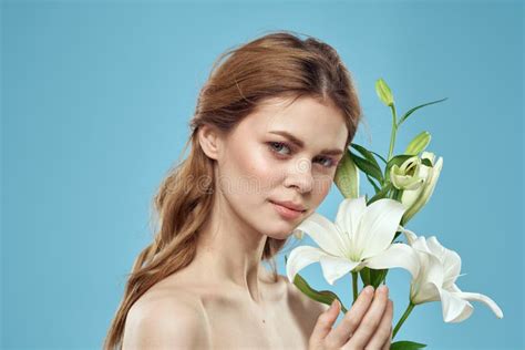 Woman With A Bouquet Of White Flowers On A Blue Background Naked Shoulders Beautiful Face Stock