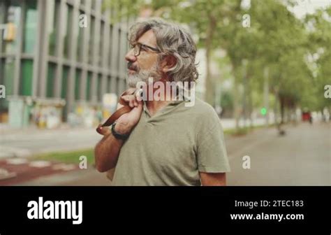 Middle Aged Man With Gray Hair And Beard Walks And Looks Around Mature