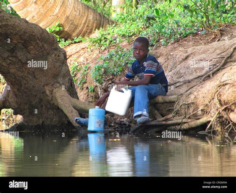 Boy Fetching Water From A River With Canister Haiti Grande Anse