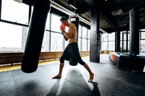 Premium Photo Guy In Red Boxing Gloves With A Naked Torso Dressed In