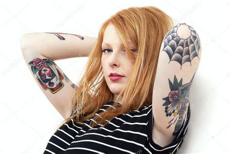 Strawberry Blonde Red Head Leaning Against Wall With Tattoo Arms