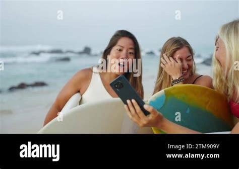 Cheerful Multiracial Surfer Girls In Bikini Taking Selfies Holding