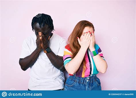 Interracial Couple Wearing Casual Clothes With Sad Expression Covering