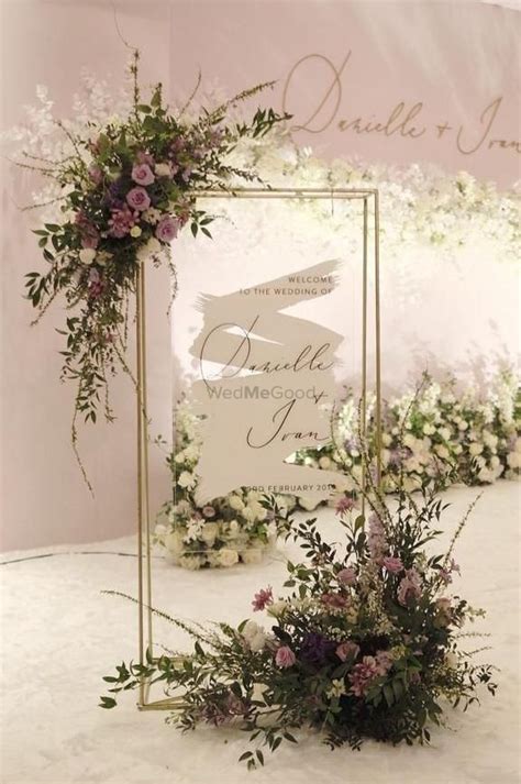 A Dreamy White And Purple Wedding Arch