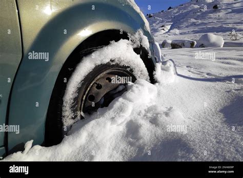 Close Up On The Front Wheel Of A Car Stuck In The Snow Stock Photo Alamy