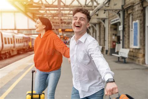 Beautiful Couple At Railway Station Waiting For The Train Woman And Man Running To Board A