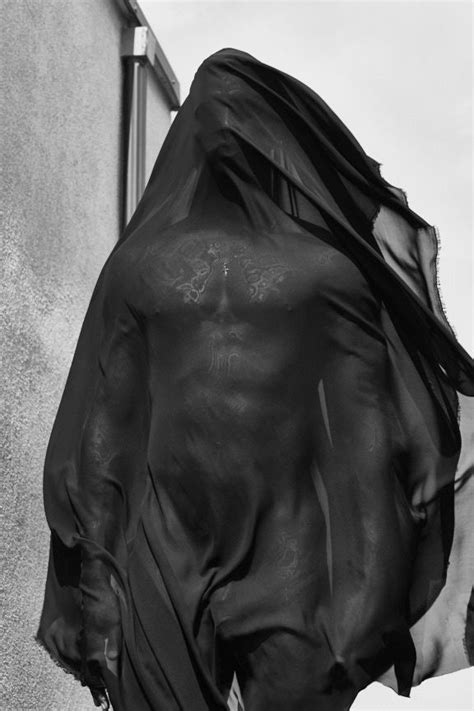 A Black And White Photo Of A Man S Torso