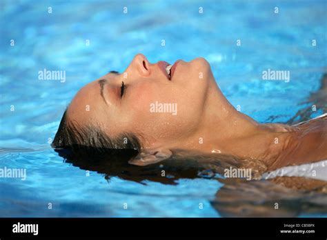 Woman Laying In Swimming Pool Stock Photo Alamy