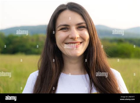 Portrait Of A Year Old Brunette Woman Looking At The Camera Smiling In Nature Stock Photo Alamy