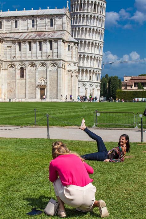 Tourists Posing And Taking Pictures In Front Of The Famous Leaning