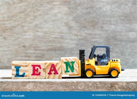 Toy Forklift Hold Letter Block N To Word Lean On Wood Background Stock