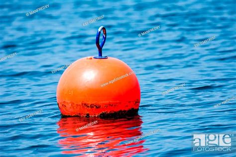 Orange Buoy Floating In Blue Water Stock Photo Picture And Low Budget