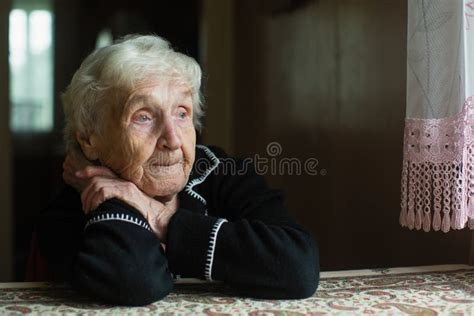 Old Lady Grandma Comforting A Crying Little Girl Granddaughter Stock