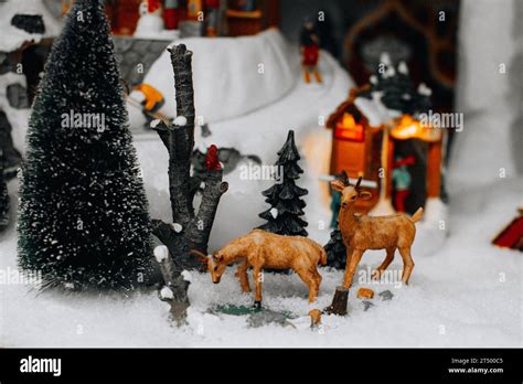 Christmas Figures Of Deers And Christmas Tree In The Snowy Street